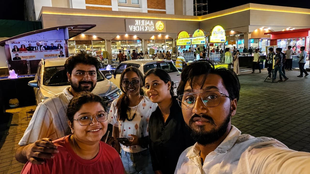 Friends posing for a selfie outside Amrik Sukhdev, Murthal, during a late-night road trip stop on their way to Jibhi.