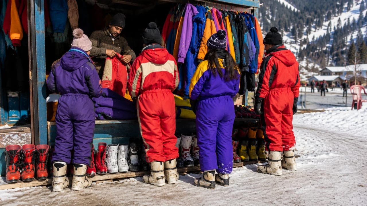Travellers renting snow clothes and boots before entering Kufri snow areas.