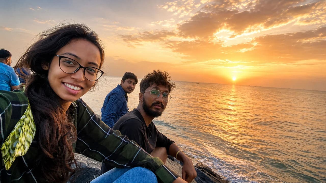 Friends sitting on Auro Beach before sunrise in Pondicherry.