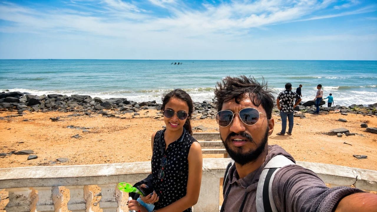 Friends walking beside Rock Beach in Pondicherry on the final day of their trip.