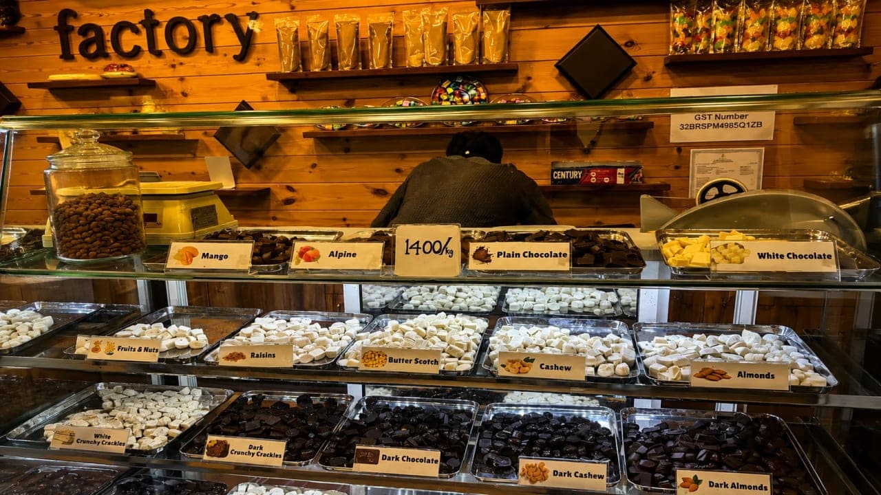 A local chocolate shop in Thekkady, Kerala, displaying a variety of homemade chocolates and regional treats.