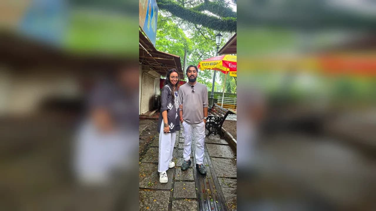 My husband and I posing together on a rain-soaked street during our final day exploring Kochi, Kerala.