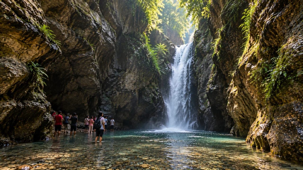 Waterfall flowing between rocky walls inside Robber’s Cave at Guchhupani Dehradun.